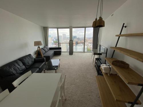 a living room with a couch and a table at Rotunda - New Street, City Centre, Birmingham in Birmingham