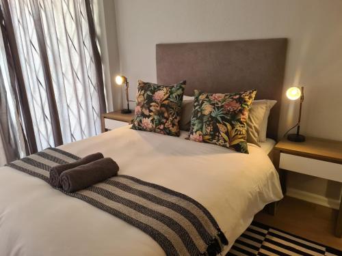een bed met twee kussens en een deken erop bij Point Village Accommodation - Santos 57 in Mosselbaai
