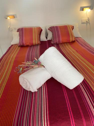 a bed with two white pillows on it at Apartamento Vista Altillo in Almuñécar