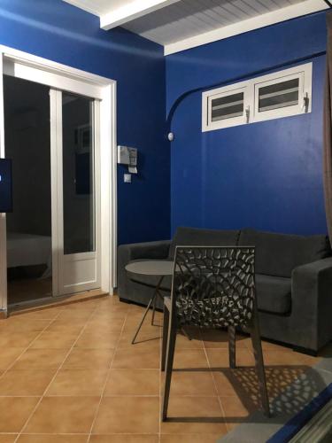a blue living room with a couch and a chair at Be On The Beach in Sainte-Anne
