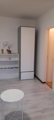 a room with a white table and a white door at Anna's Home in Campione dʼItalia