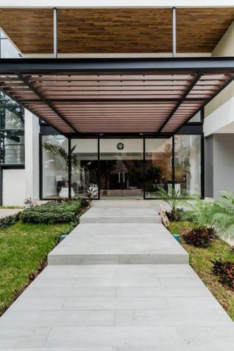 a walkway leading into a building with a wooden ceiling at ☆Brand new 2BR PH by CASA PARAISO☆ in Cancún