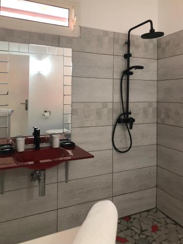 a bathroom with a shower and a sink at Be On The Beach in Sainte-Anne