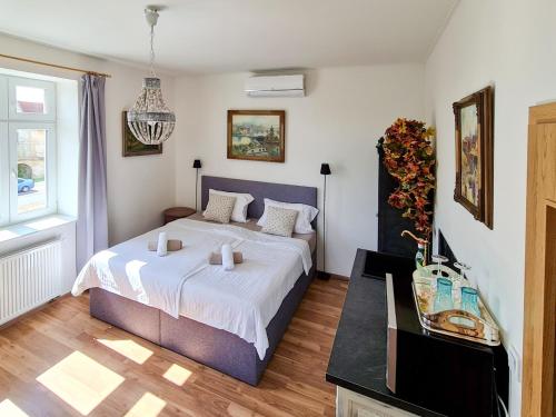 a bedroom with a king sized bed and a table at Apartmán Praha Břevnov in Prague