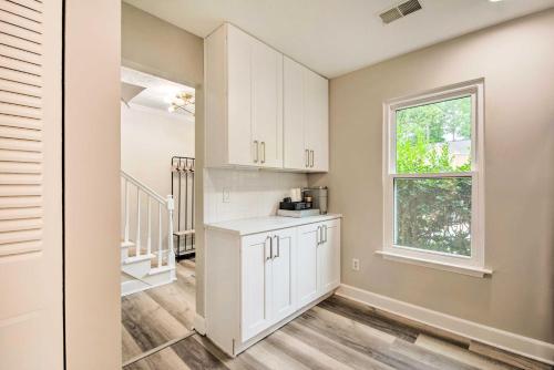 a kitchen with white cabinets and a window at Updated Retreat 2 Mi to Truist Park and Battery in Atlanta