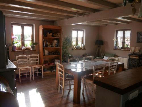 a dining room with a table and chairs at Chambres d'hôtes "La Bouill'hôte" in Langensoultzbach