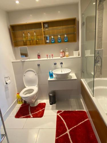 a bathroom with a toilet and a sink at 1 Bed- Dedicated Workspace, Coffee maker 4KTV in London