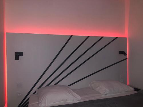 a bed in a room with a red light at Be On The Beach in Sainte-Anne