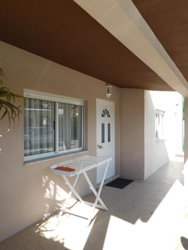 a room with a white table in front of a house at Casa da Veiga in Lago