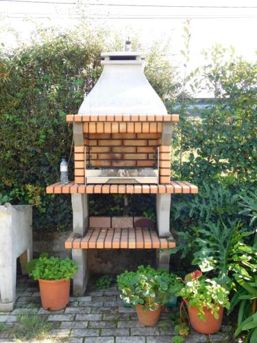 a small bird house sitting on a brick patio at Casa da Veiga in Lago