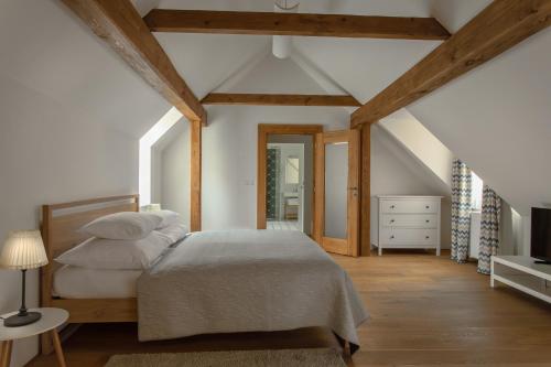 1 dormitorio con 1 cama, vestidor y TV en Hotel At the White Lily en Praga