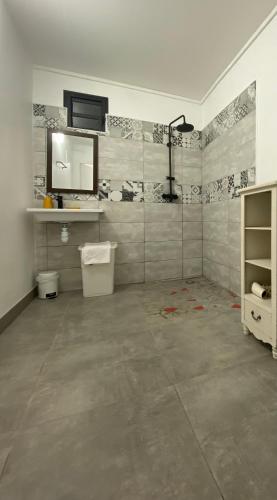 a bathroom with a sink and a mirror on the wall at Be On The Beach in Sainte-Anne