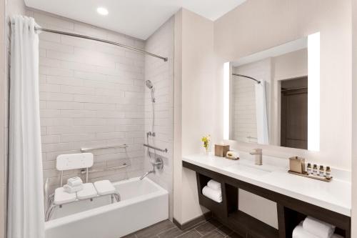 a white bathroom with a tub and a sink at Hyatt Regency Sonoma Wine Country in Santa Rosa