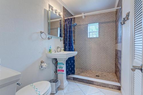a bathroom with a sink and a shower at Bathing Suit Beach Bungalow in Ormond Beach