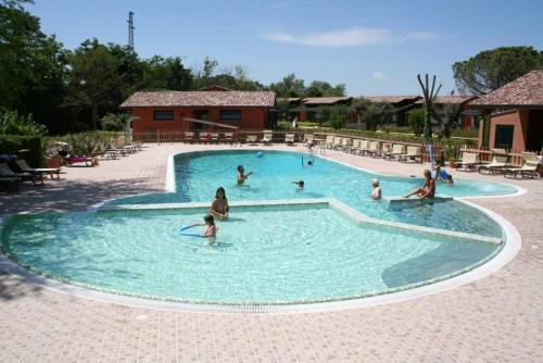 a group of people in a swimming pool at Due Ponti Village in Cesenatico