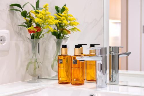 a bathroom sink with yellow flowers and a mirror at Savannah Apartment, by Bolhão Residences in Porto