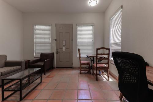 a living room with a couch and a table and chairs at The Bungalows on Shary in McAllen