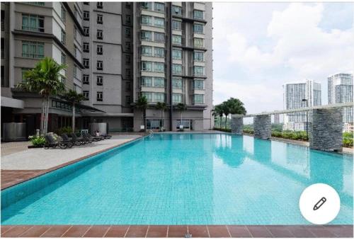 a large swimming pool in front of a building at Shaftsbury Residence Cyberjaya Wifi, Netflix, Free Parking in Cyberjaya
