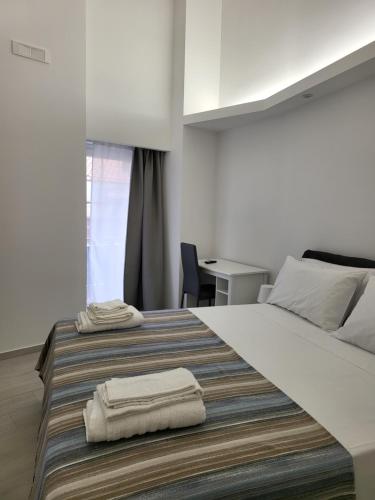 1 dormitorio con 1 cama grande y toallas. en Casa vacanze Al Porto en Catania
