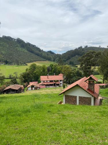 a group of buildings in a field of grass at La Posada De Los Arcángeles in Madrid