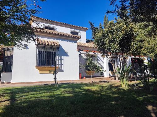 a white house with a window and a yard at The Magic House in El Puerto de Santa María
