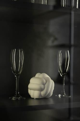 two wine glasses and a white napkin on a table at RentWill apartments Gold in Chişinău