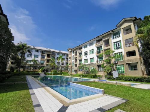 a swimming pool in front of some apartment buildings at Eden 8pax 3Rooms apartment near Kuching Airport in Kuching