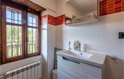 a bathroom with a sink and a window at 1 Bedroom Gorgeous Apartment In Bossolasco in Bossolasco