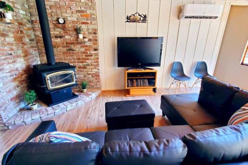 a living room with a couch and a fireplace at Redwood Retreat, Mountains, Adventure and Nature in Ponderosa