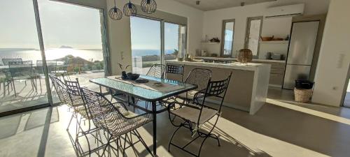 a table and chairs in a kitchen with a view at Komos Beach Estate in Kalamaki