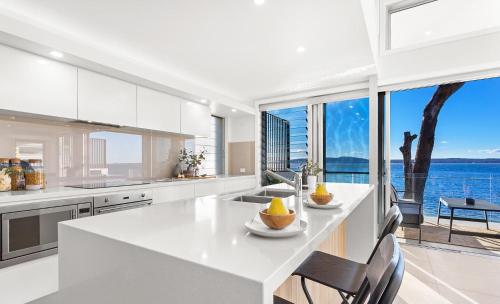 a kitchen with a view of the water at Baydream on the Beach - With Breathtaking Water Views in Corlette