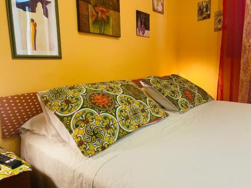 a bed with two pillows on top of it at Cottage Gole Alcantara Gloria Room in Graniti