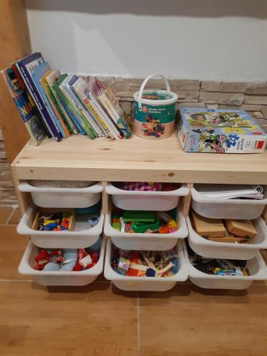 a small childs play table with drawers and toys at Hygge chaloupka v horách in Český Jiřetín