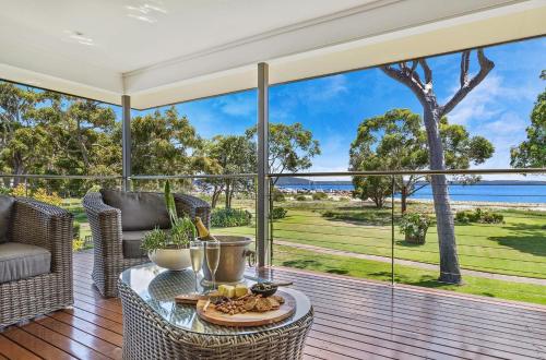 a home with a view of the ocean from the deck at Memories on the Beachfront in Corlette