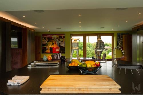 una cocina con un bol de fruta en una barra en Drystone Manor - Swim Hot Tub, Tennis, Gatherings en Iron Acton