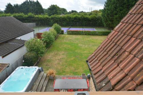an aerial view of a backyard with a swimming pool at Drystone Manor - Swim Hot Tub, Tennis, Gatherings in Iron Acton