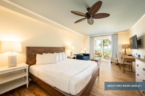 a bedroom with a bed and a ceiling fan at Grassy Flats Resort & Beach Club in Marathon