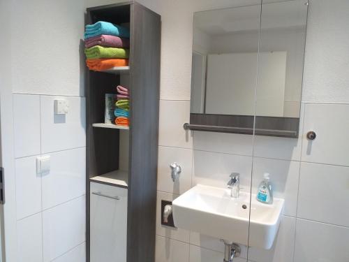 a bathroom with a sink and a mirror at Kleine Auszeit in Rust