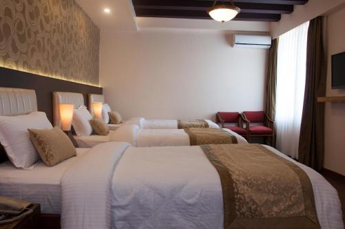 Postel nebo postele na pokoji v ubytování Mandala Boutique Hotel