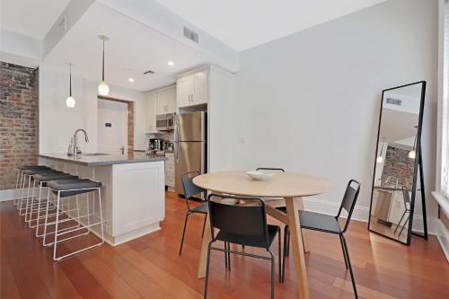 a kitchen and dining room with a table and chairs at Roami at Factors Row in New Orleans