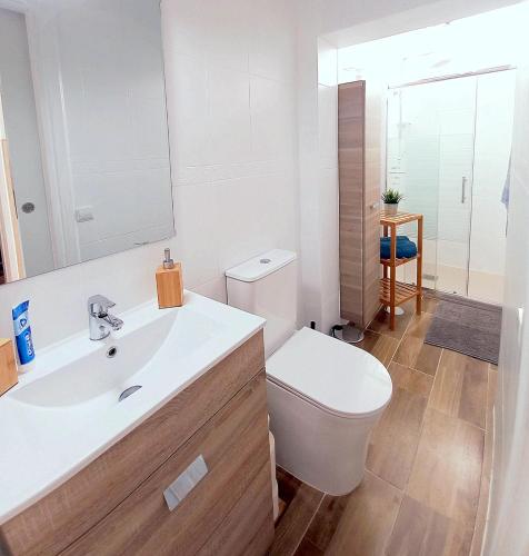 a bathroom with a white toilet and a sink at Jandia Mar 4 in Morro del Jable