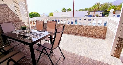 a balcony with a table and chairs on a balcony at Jandia Mar 4 in Morro del Jable