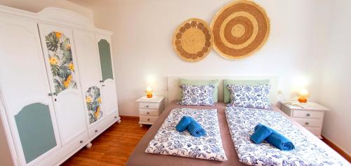 a bedroom with a bed with two blue pillows at Jandia Mar 4 in Morro del Jable