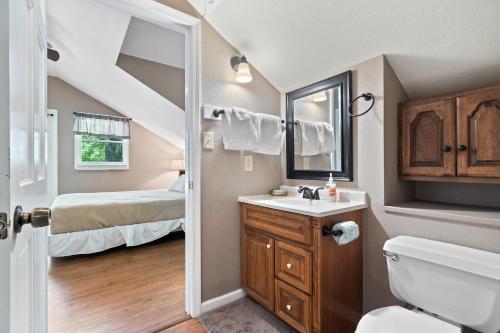 a bathroom with a sink and a toilet and a bedroom at Wilstem Cabins in French Lick