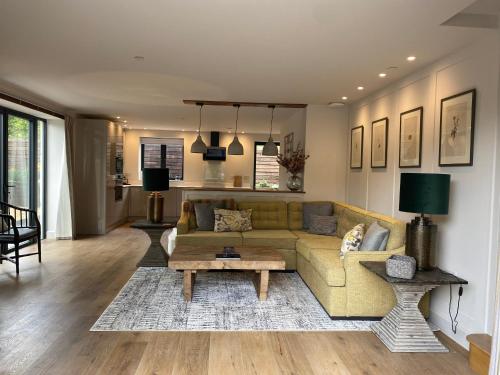 a living room with a couch and a table at Linhay Cottages in Box