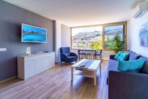 a living room with a couch and a table at La Cascada 202 in Puerto Rico de Gran Canaria