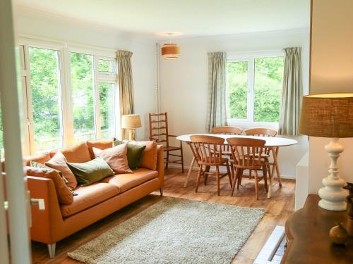 a living room with a couch and a table at Henllys Lodge in Velindre-farchog