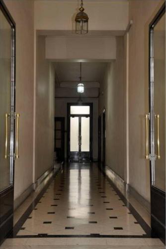 an empty hallway in a building with a long corridor at Apartment Castillo in Buenos Aires