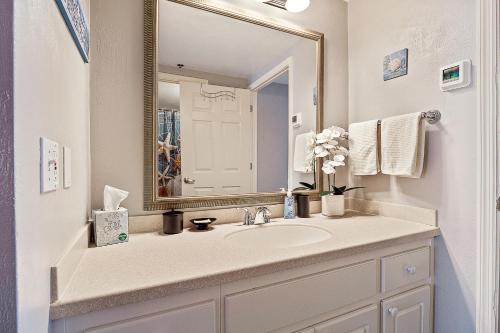 a bathroom with a sink and a mirror at Sunrise & Beach View - Daytona Beach Resort in Daytona Beach