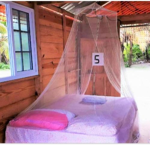 a bed in a tent with the number on it at Cabañas Waili in Niatupo